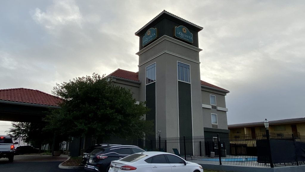 a building with a tower and cars parked in front of it