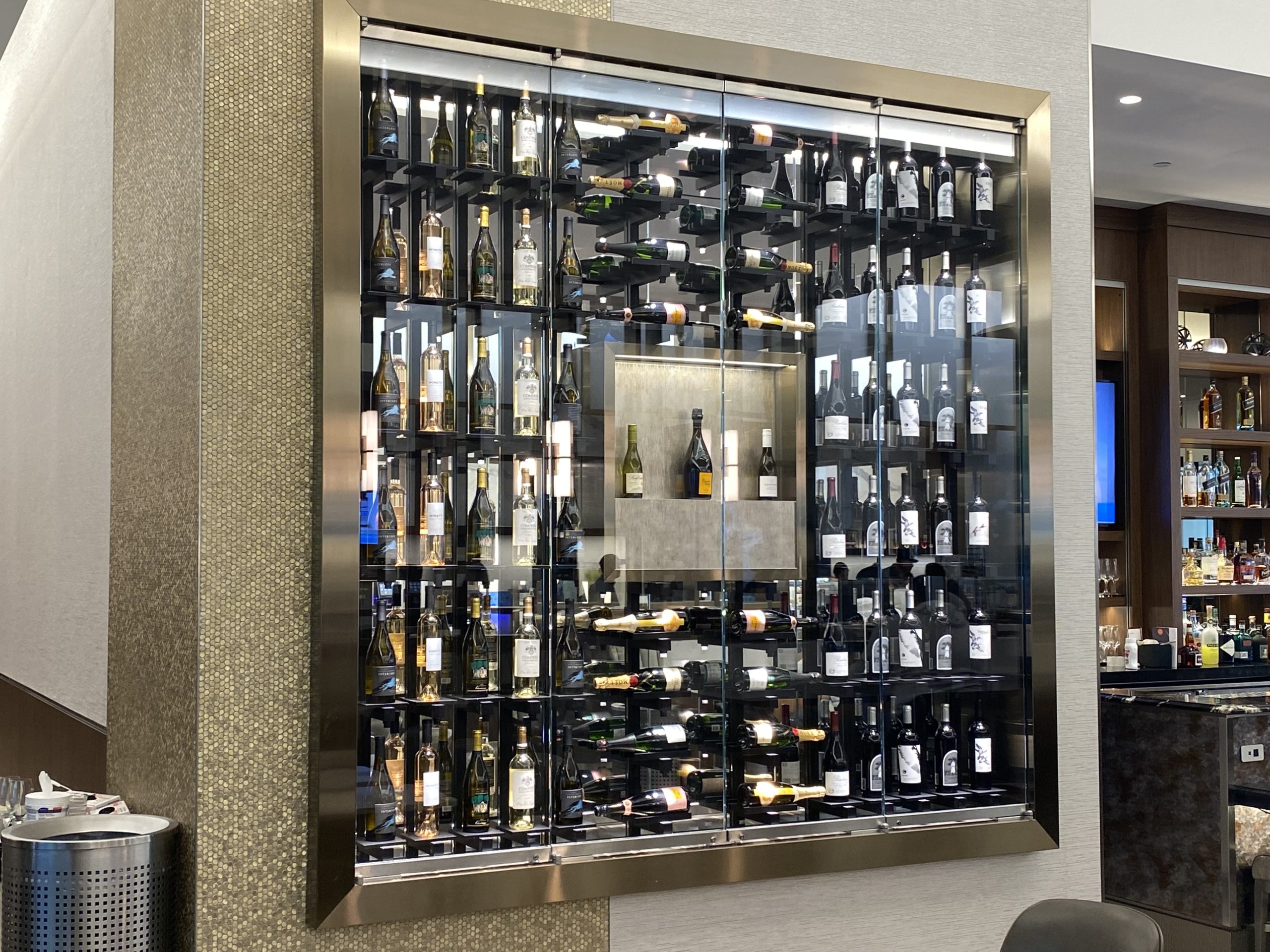 a glass case with bottles of alcohol