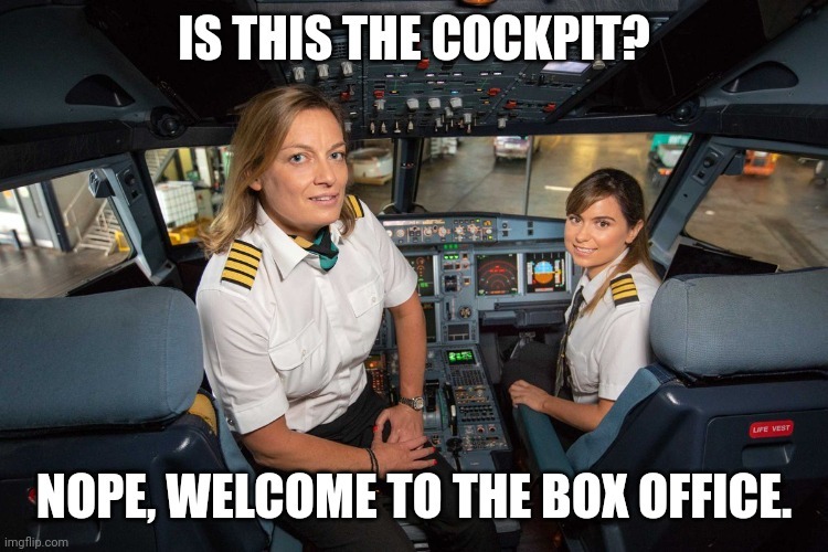 two women in uniform sitting in a cockpit