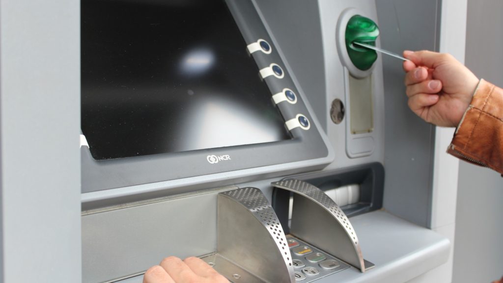 a person using a machine to pay for money