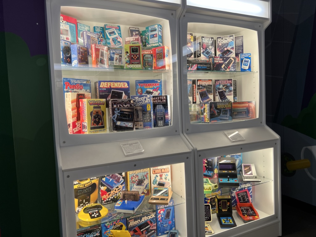 a display case with various video game items