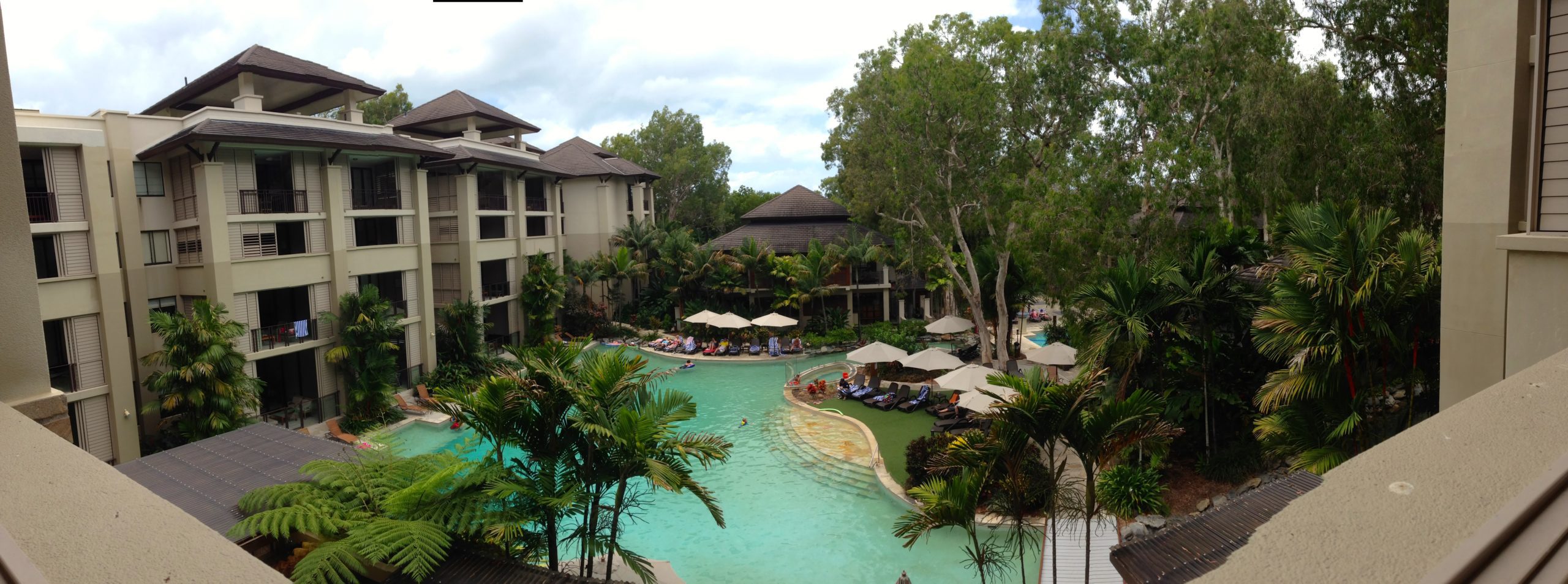 a pool with umbrellas and people in it