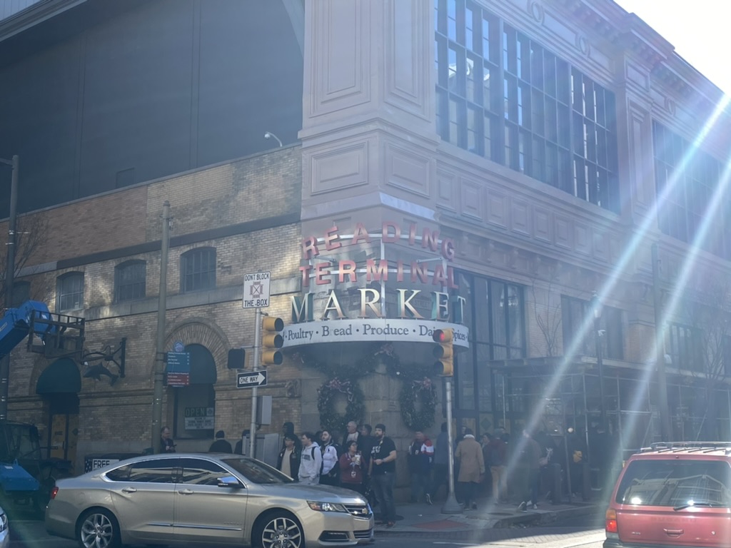 a group of people standing on the sidewalk