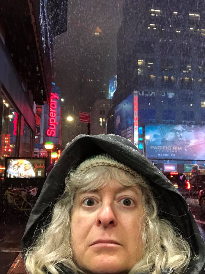 a woman taking a selfie in a city