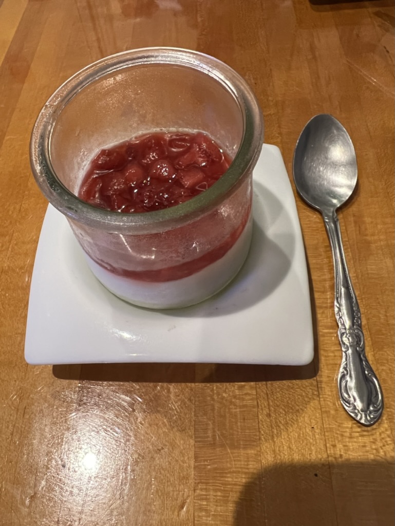 a glass jar with a spoon on a plate