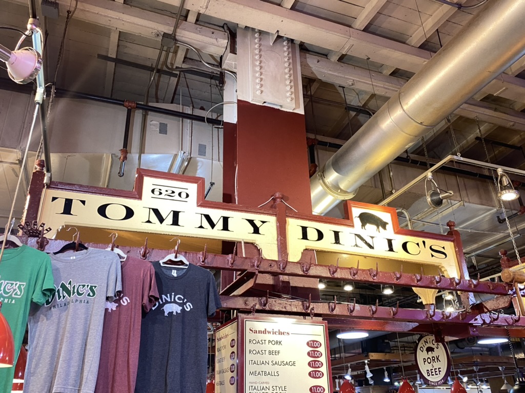 a store with t-shirts from a ceiling