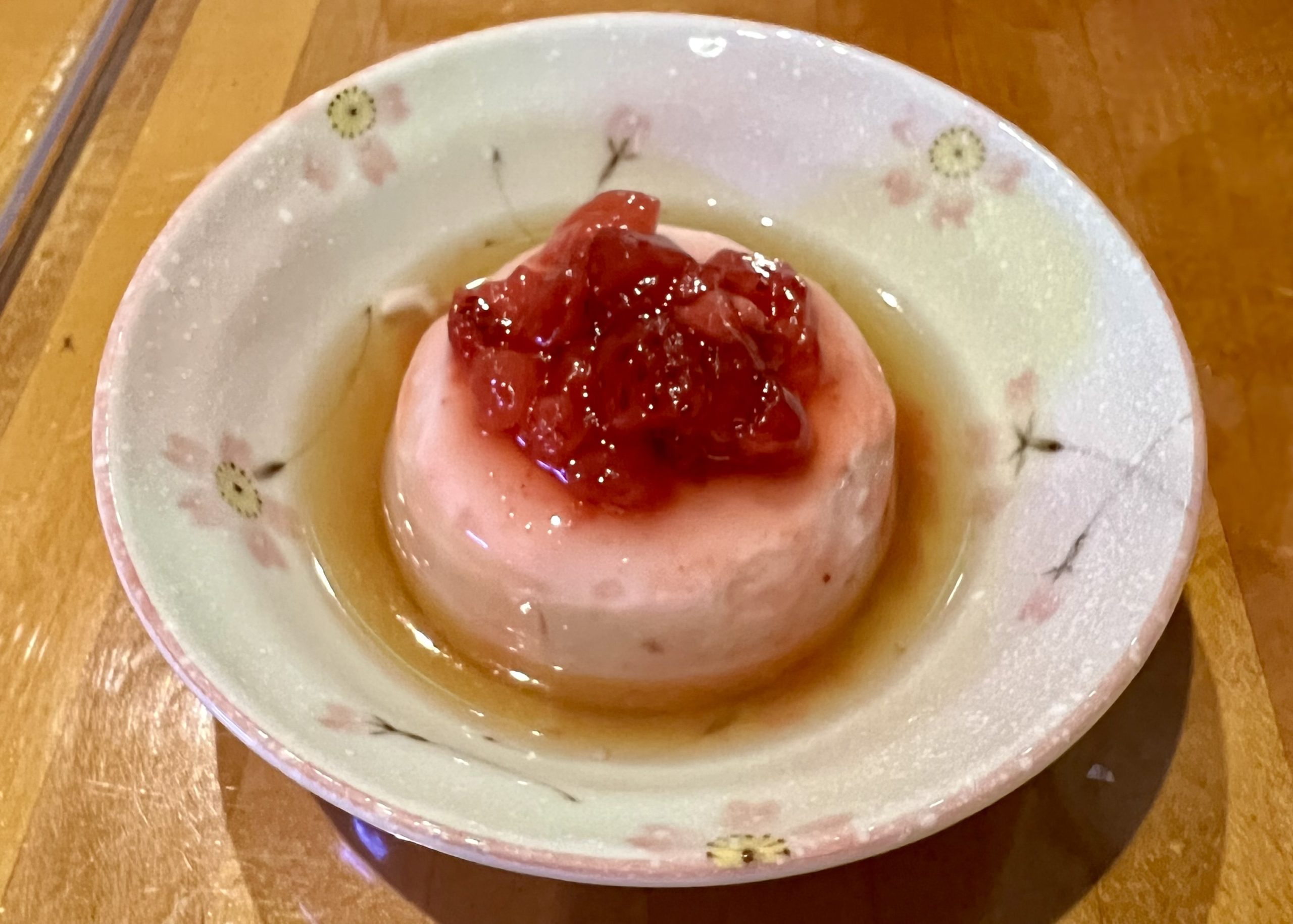 a white dessert with jelly in a bowl