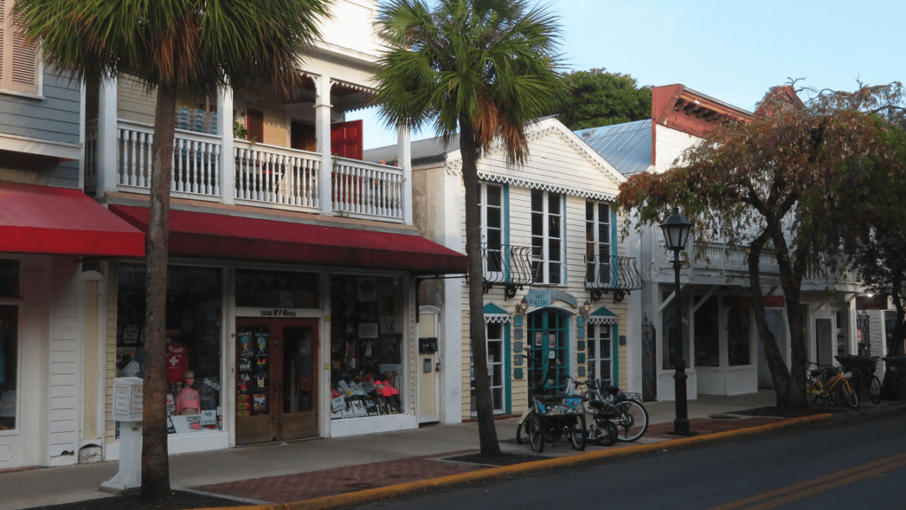 a street with shops and bicycles parked on the side