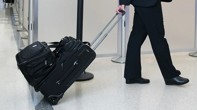 a person pulling a suitcase