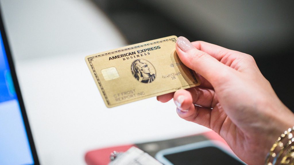 a hand holding a credit card