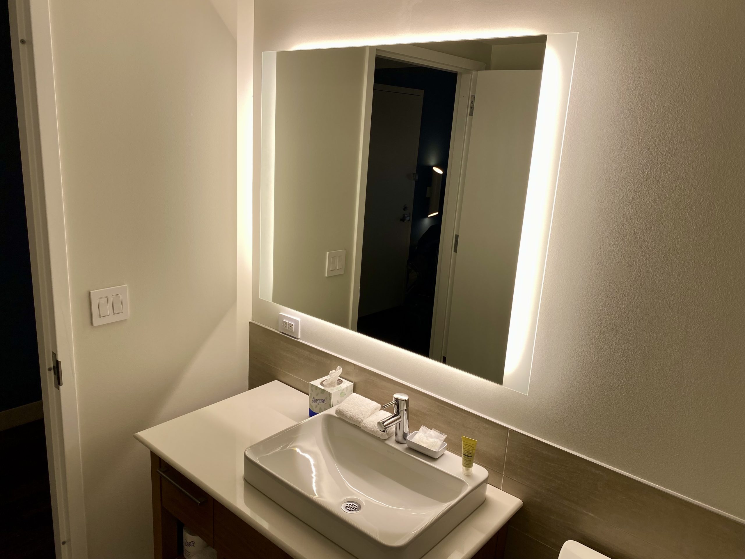 a bathroom with a mirror and sink