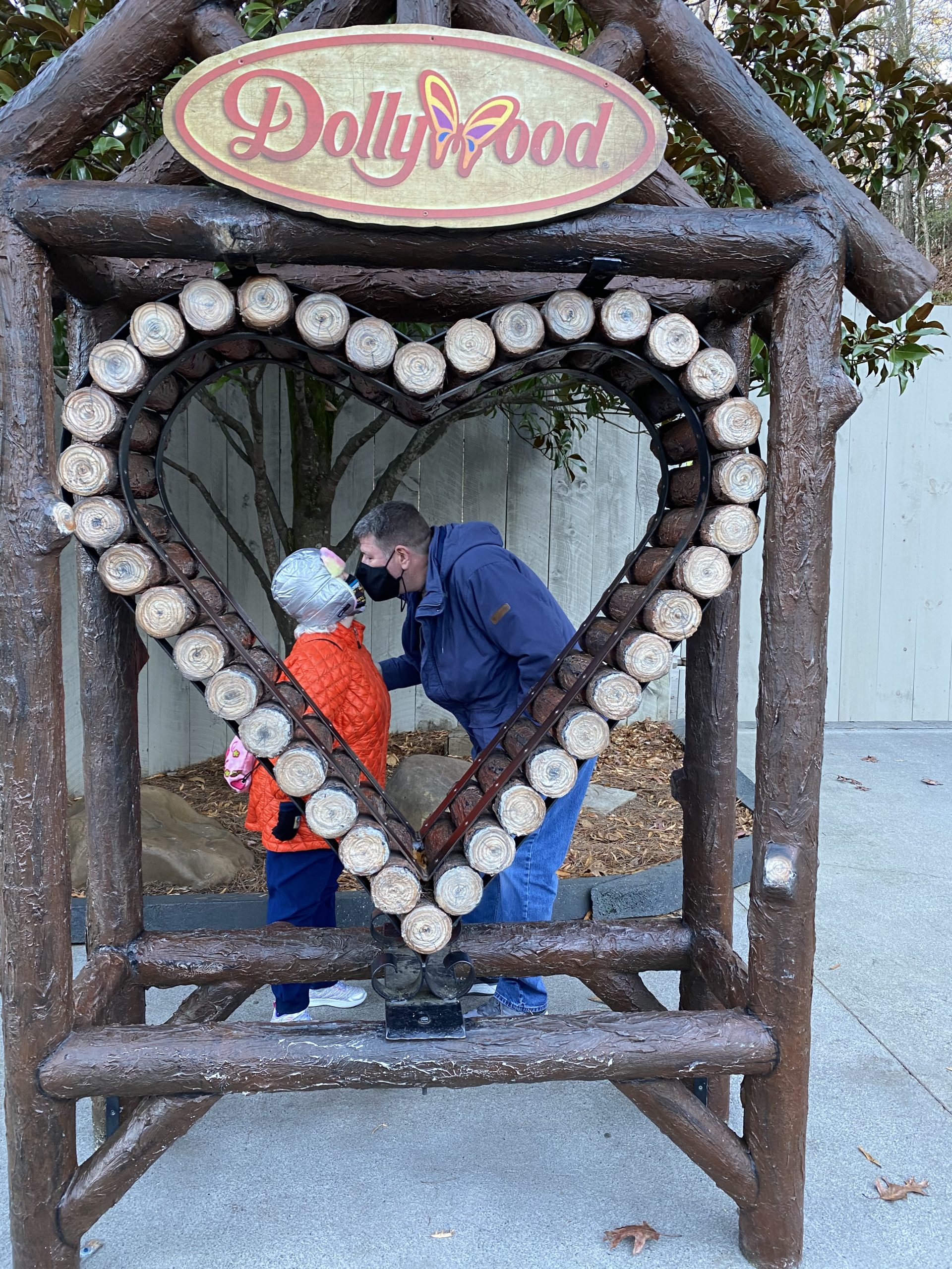 a man and child kissing in a heart shaped structure