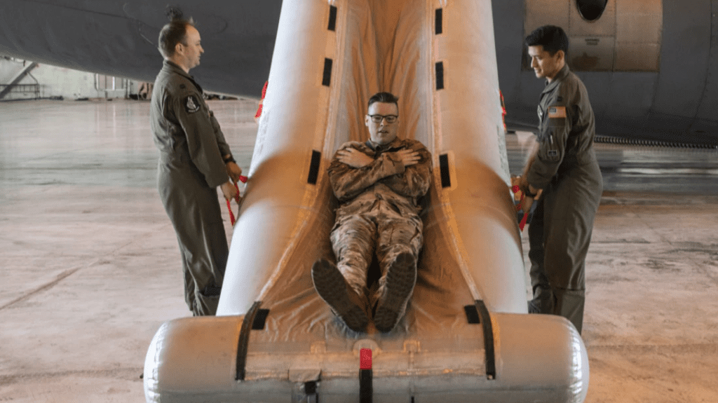 a man in military uniform lying on a slide