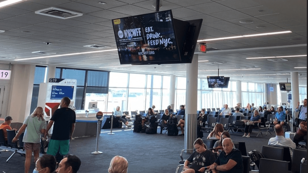 a group of people sitting in chairs in an airport