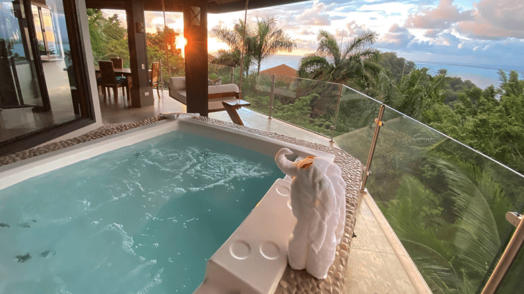 a person in a bathrobe standing next to a hot tub