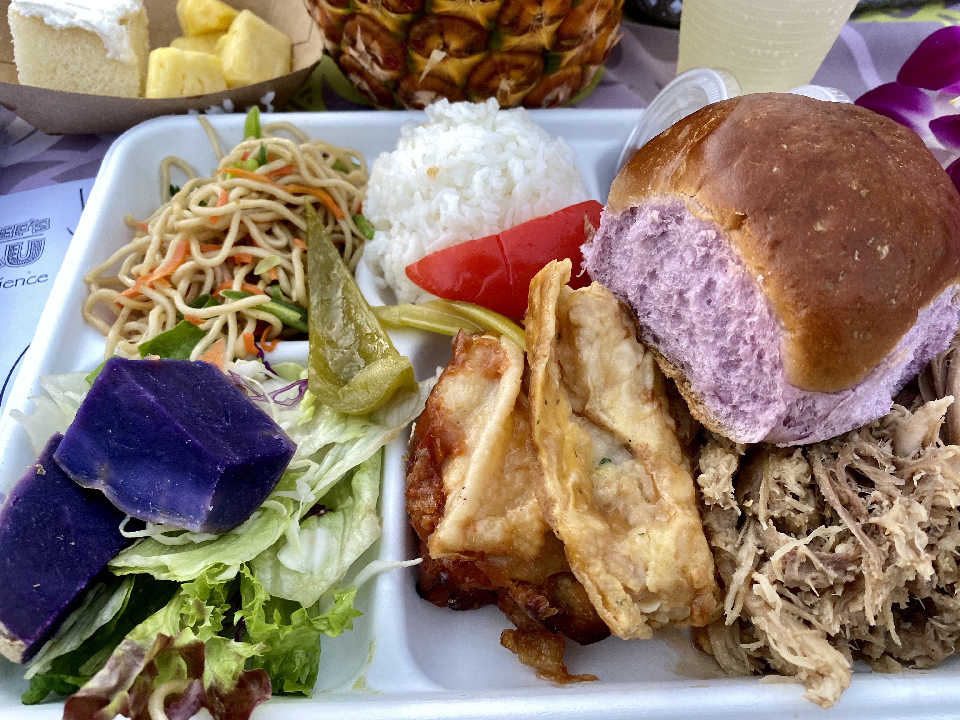 a tray of food with a sandwich and salad
