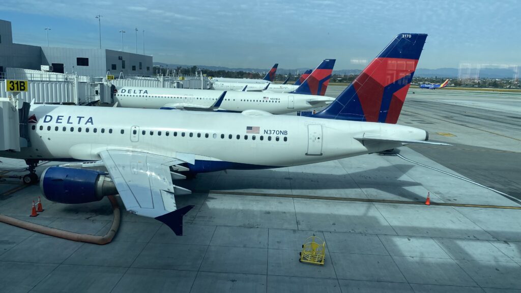 a group of airplanes parked at an airport