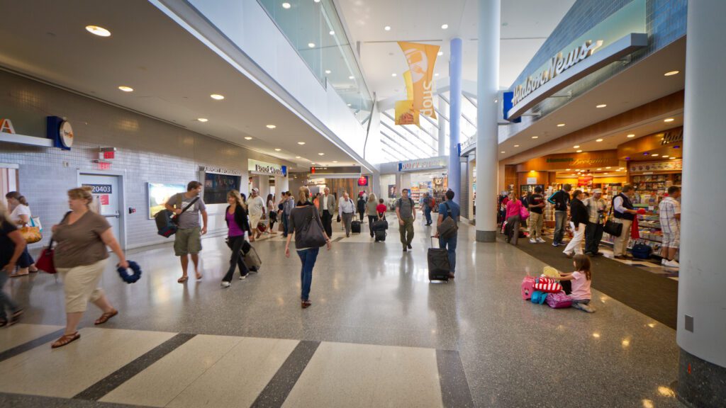 a group of people walking in a large airport