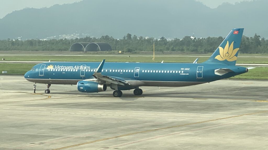 a blue airplane on a runway