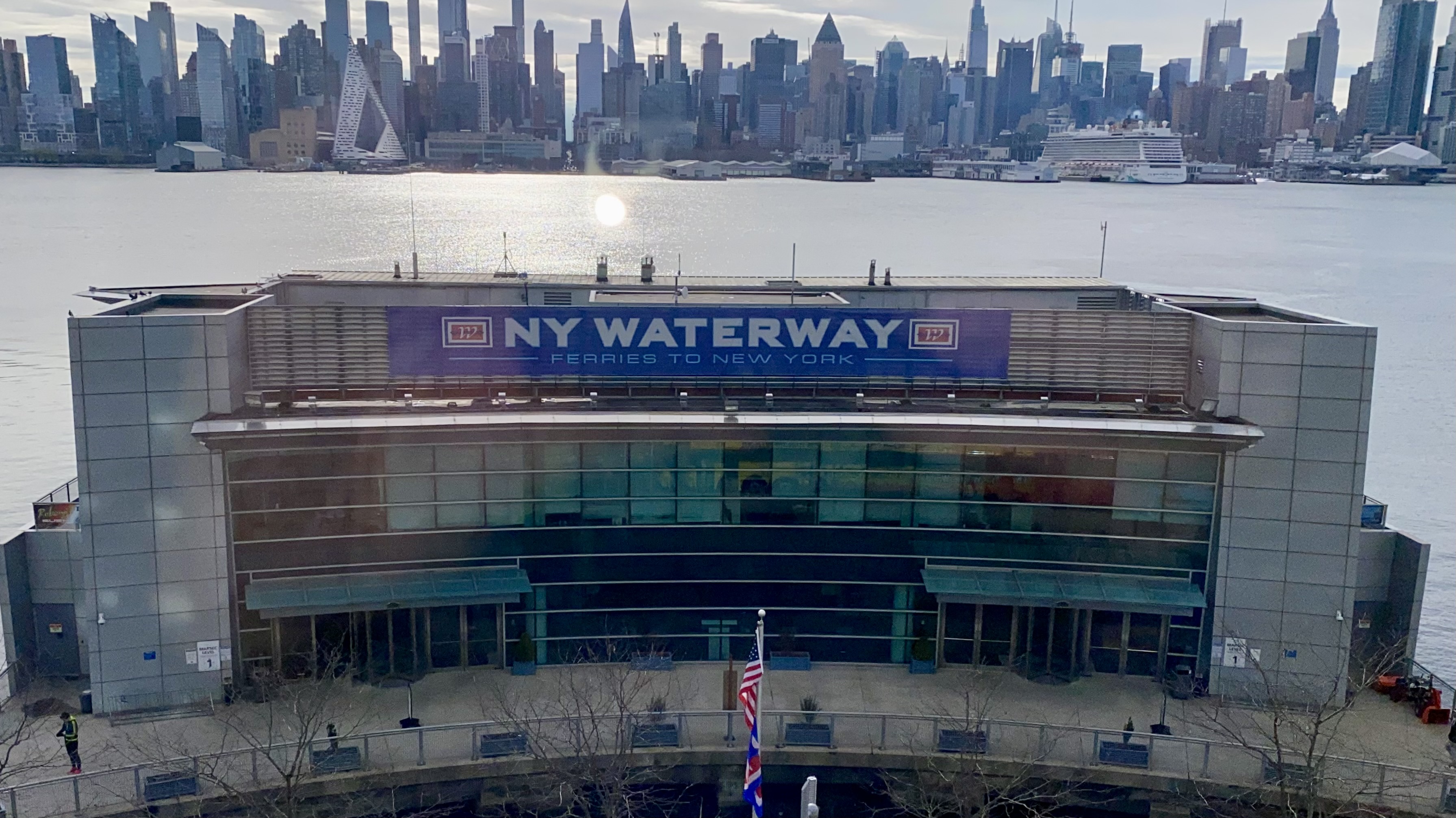 a building with a large body of water and a city in the background