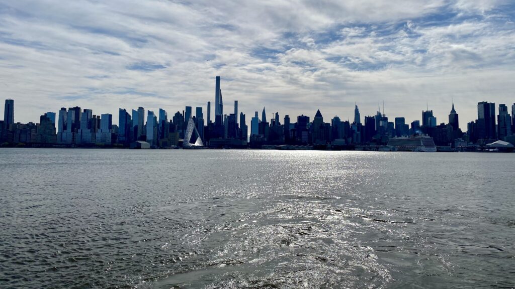 a city skyline with a body of water