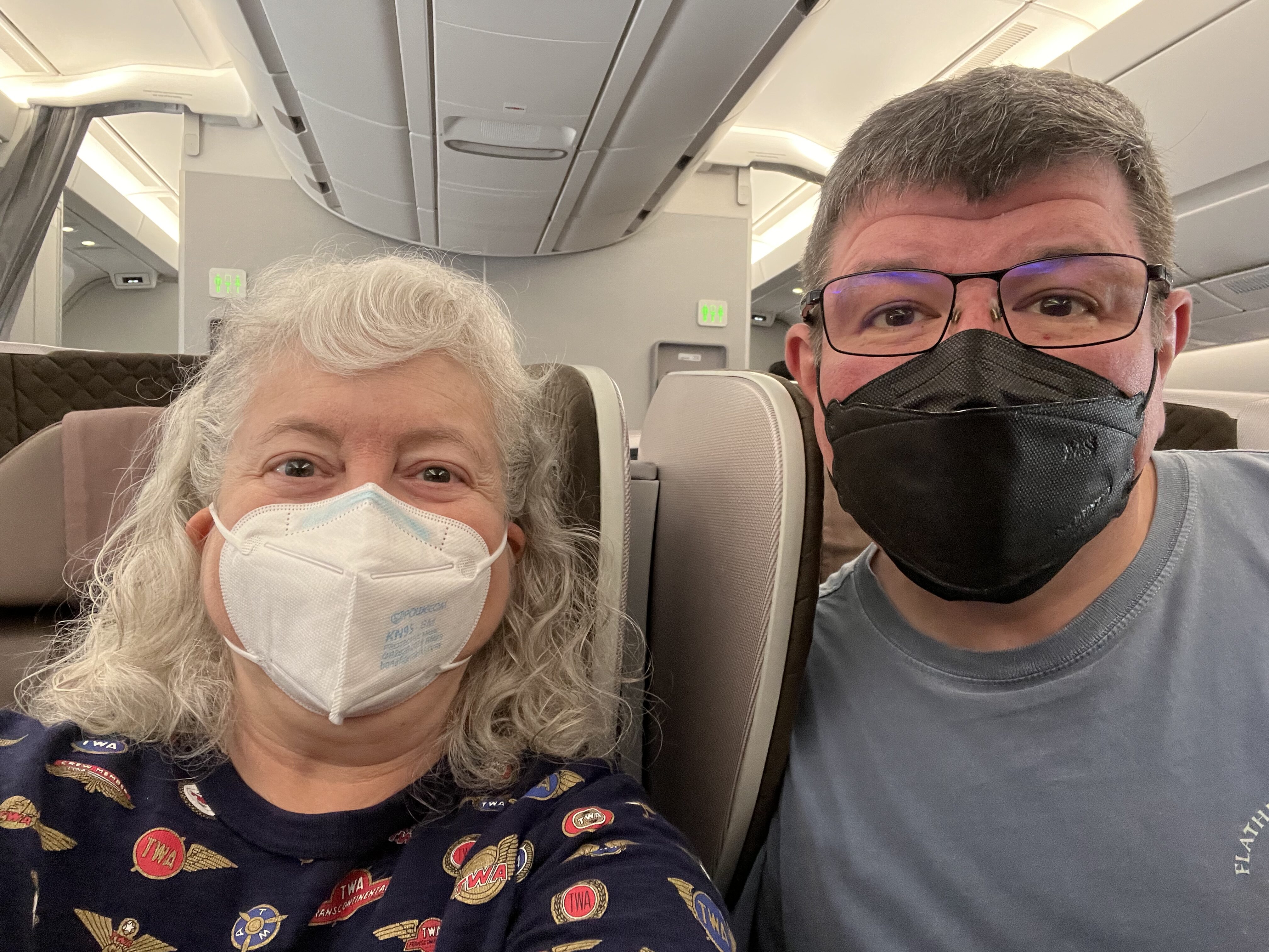 a man and woman wearing face masks