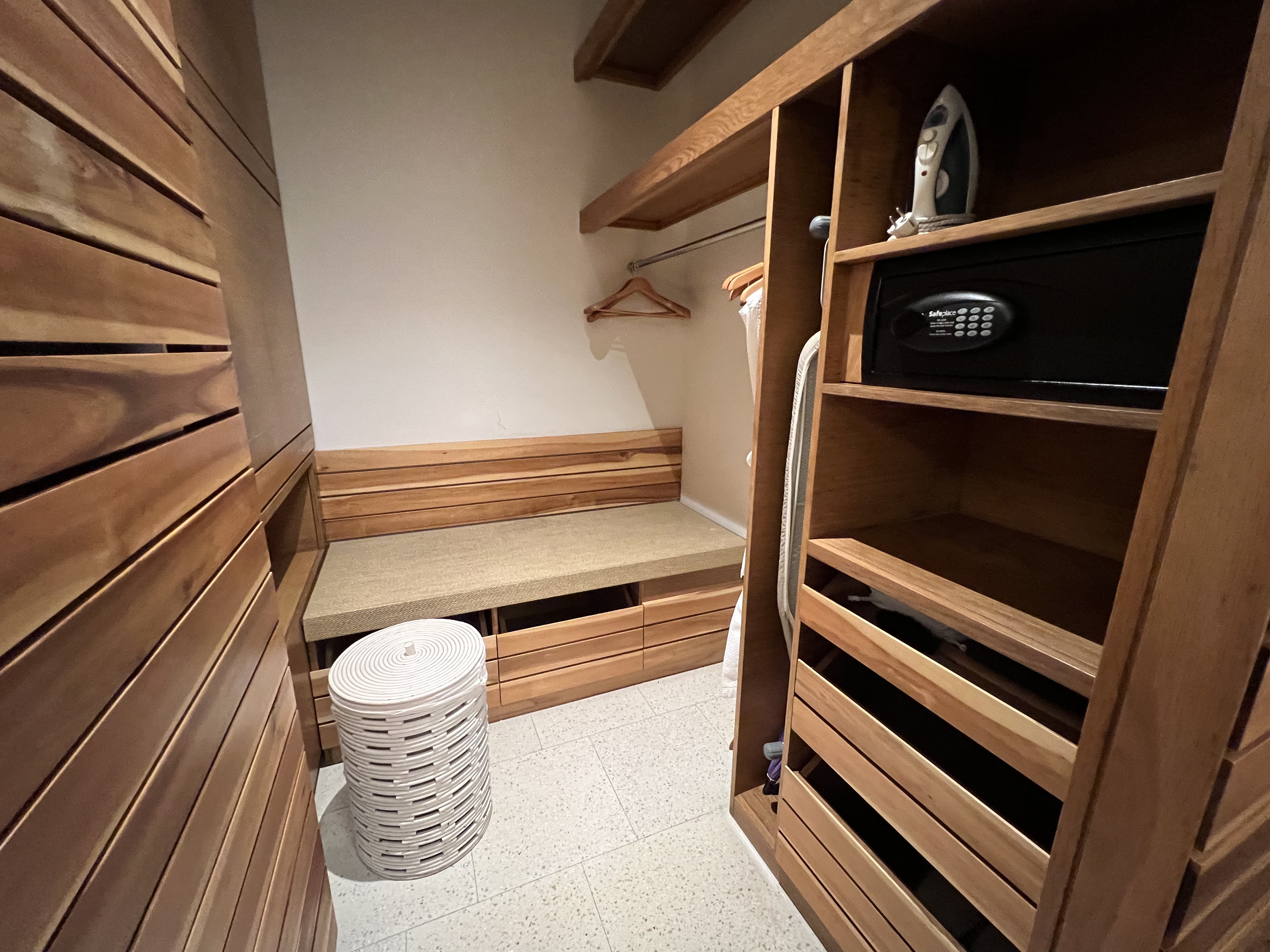 a closet with a bench and shelves