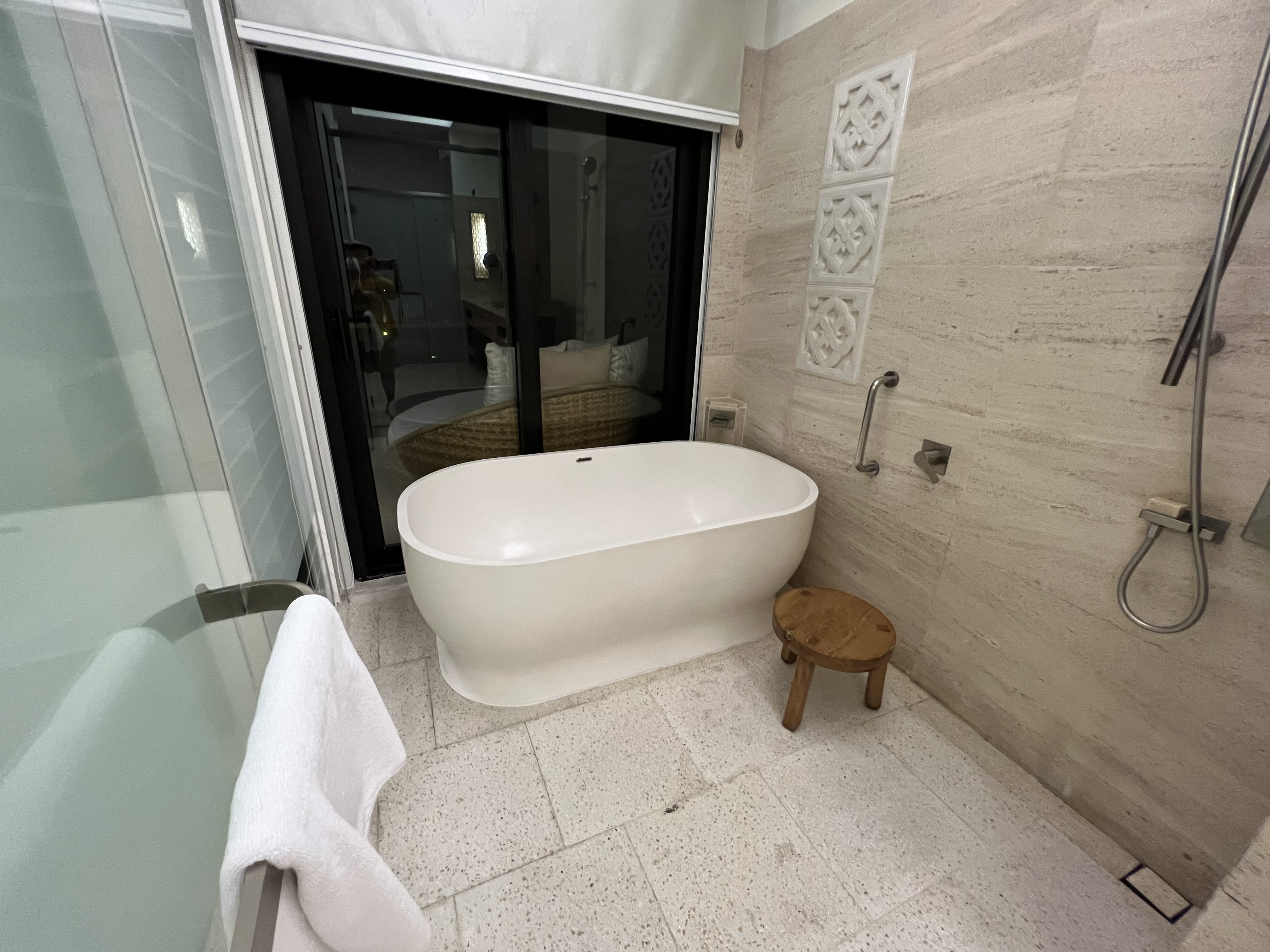 a bathroom with a tub and a shower door