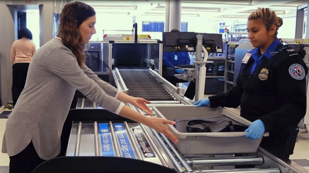 a woman standing next to a conveyor belt