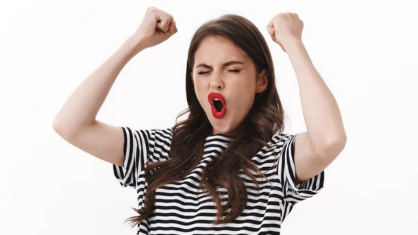 a woman with red lips and black and white striped shirt with her mouth open and her eyes closed