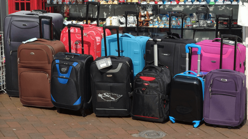 a group of luggage on a brick surface