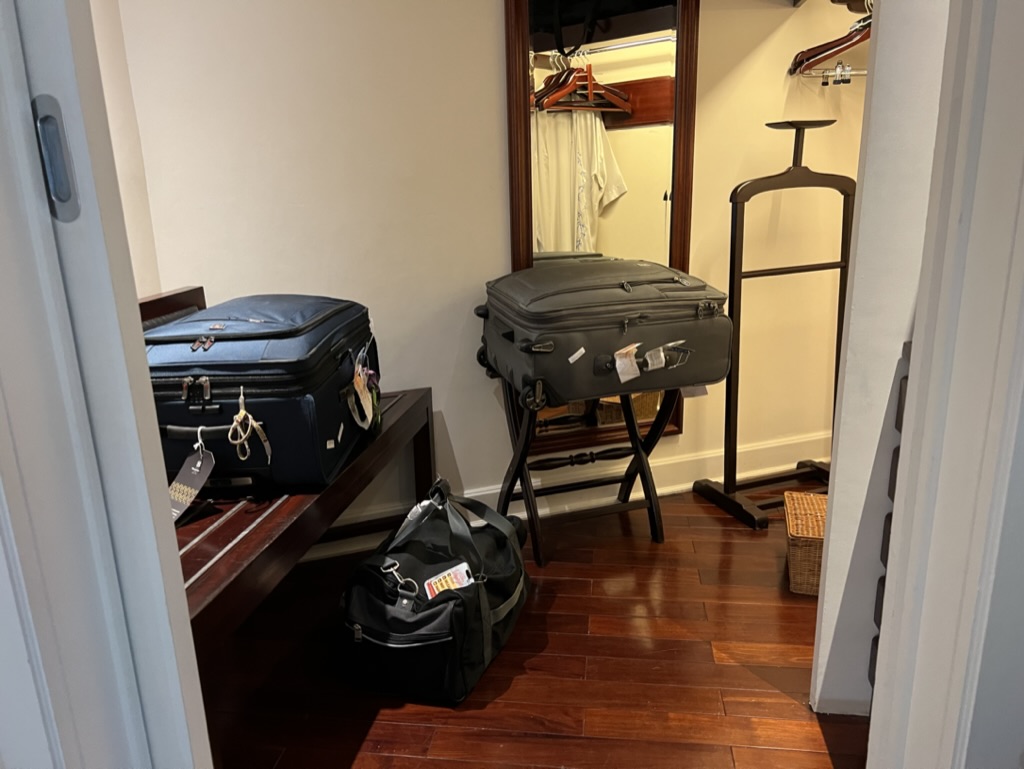 a room with luggage on a bench