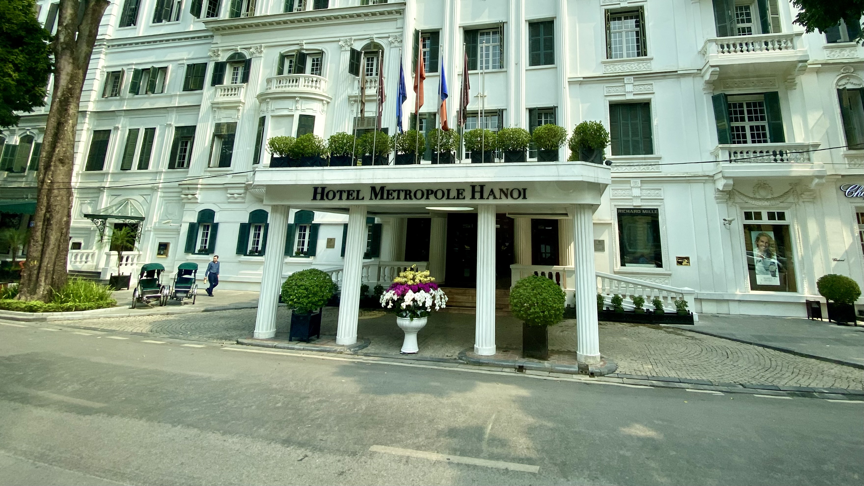 a white building with columns and flags