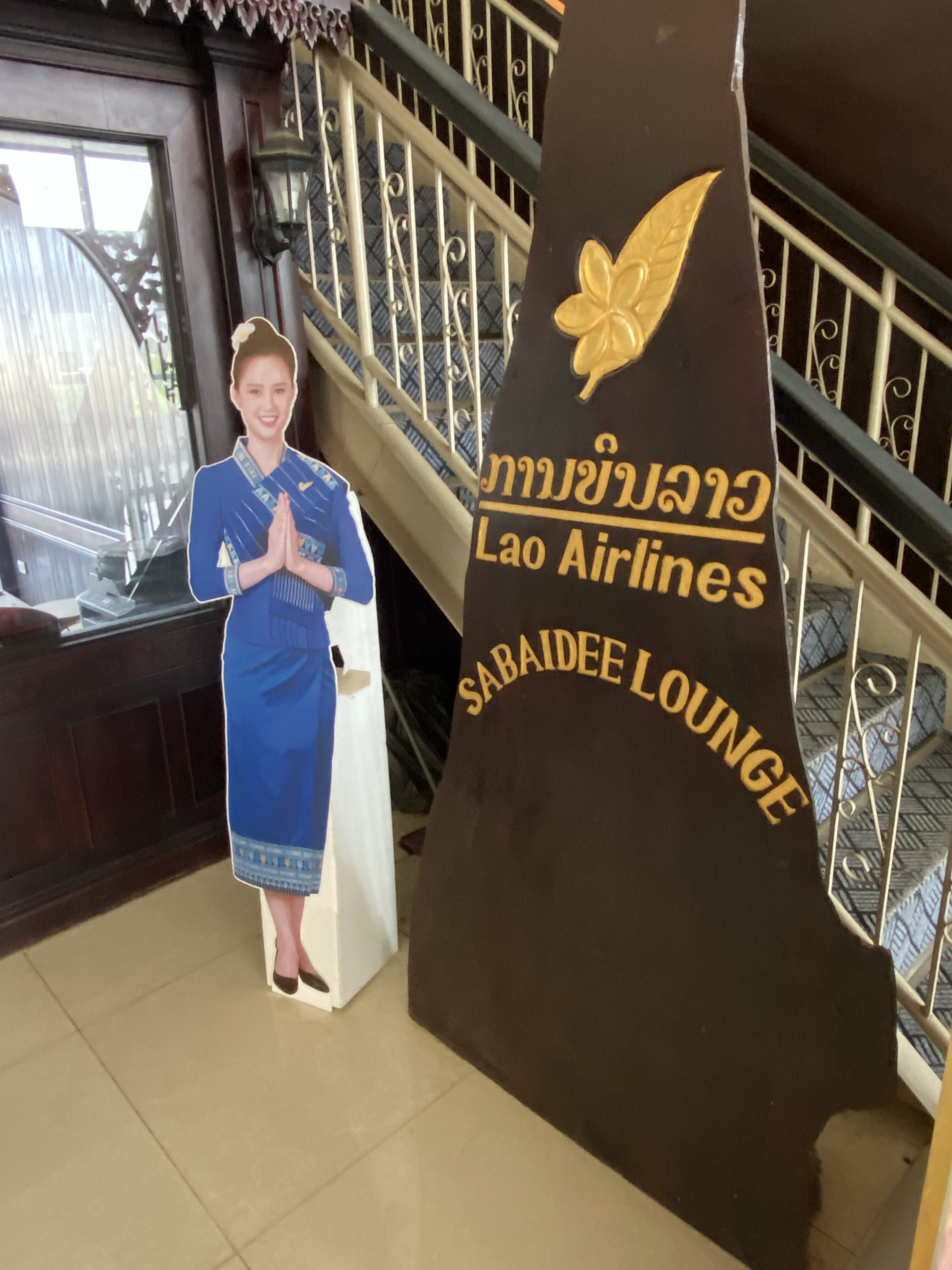 a cardboard cutout of a woman standing next to a sign