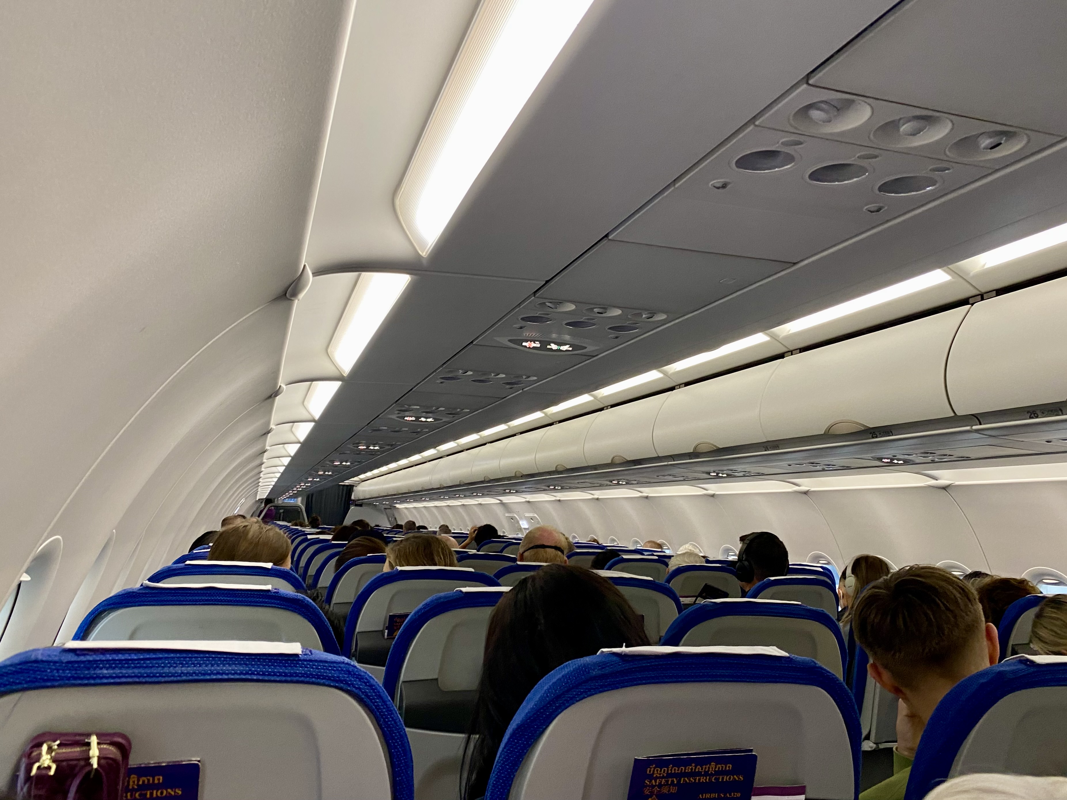 a group of people sitting in an airplane