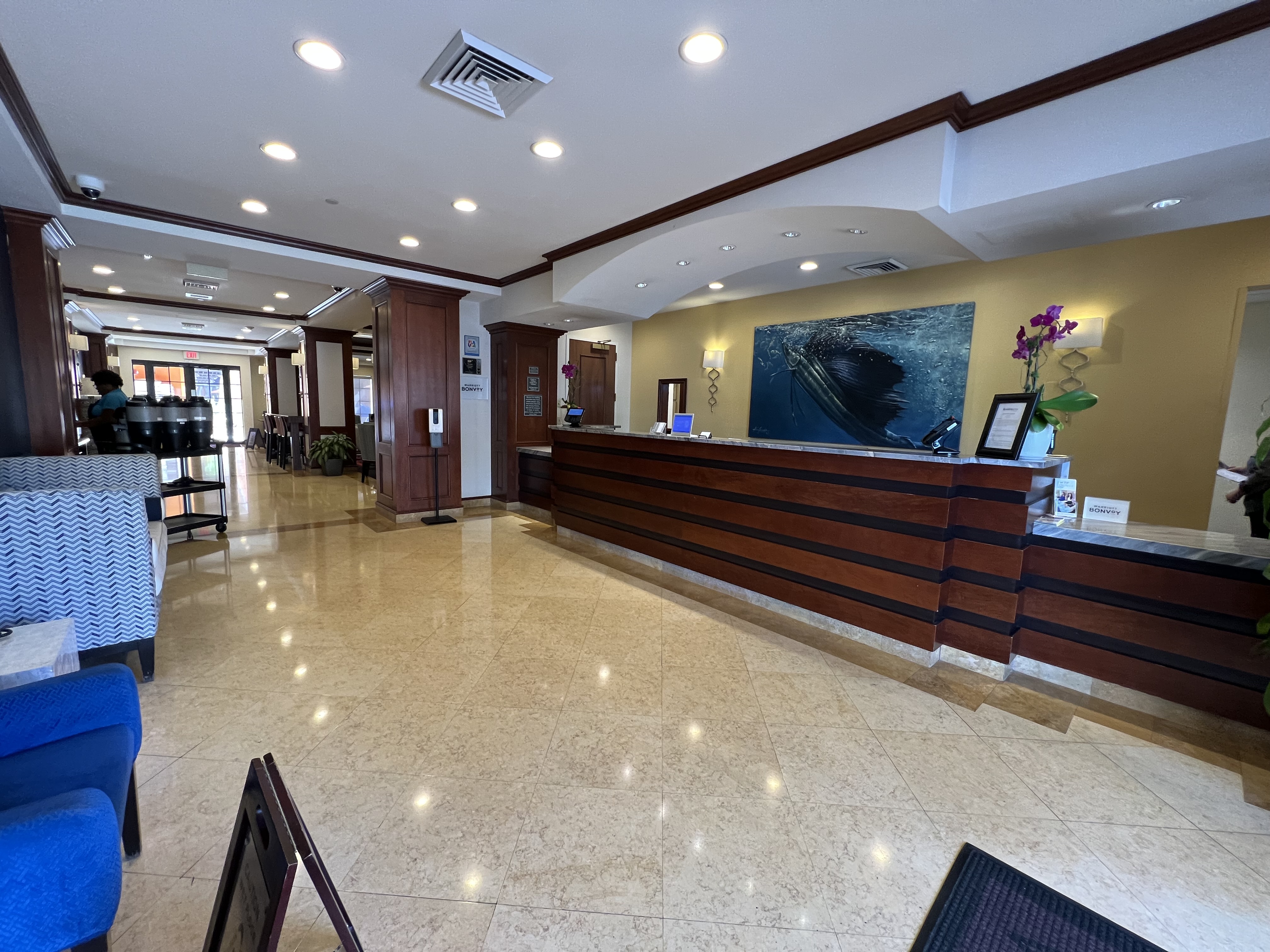 a lobby with a reception desk and chairs