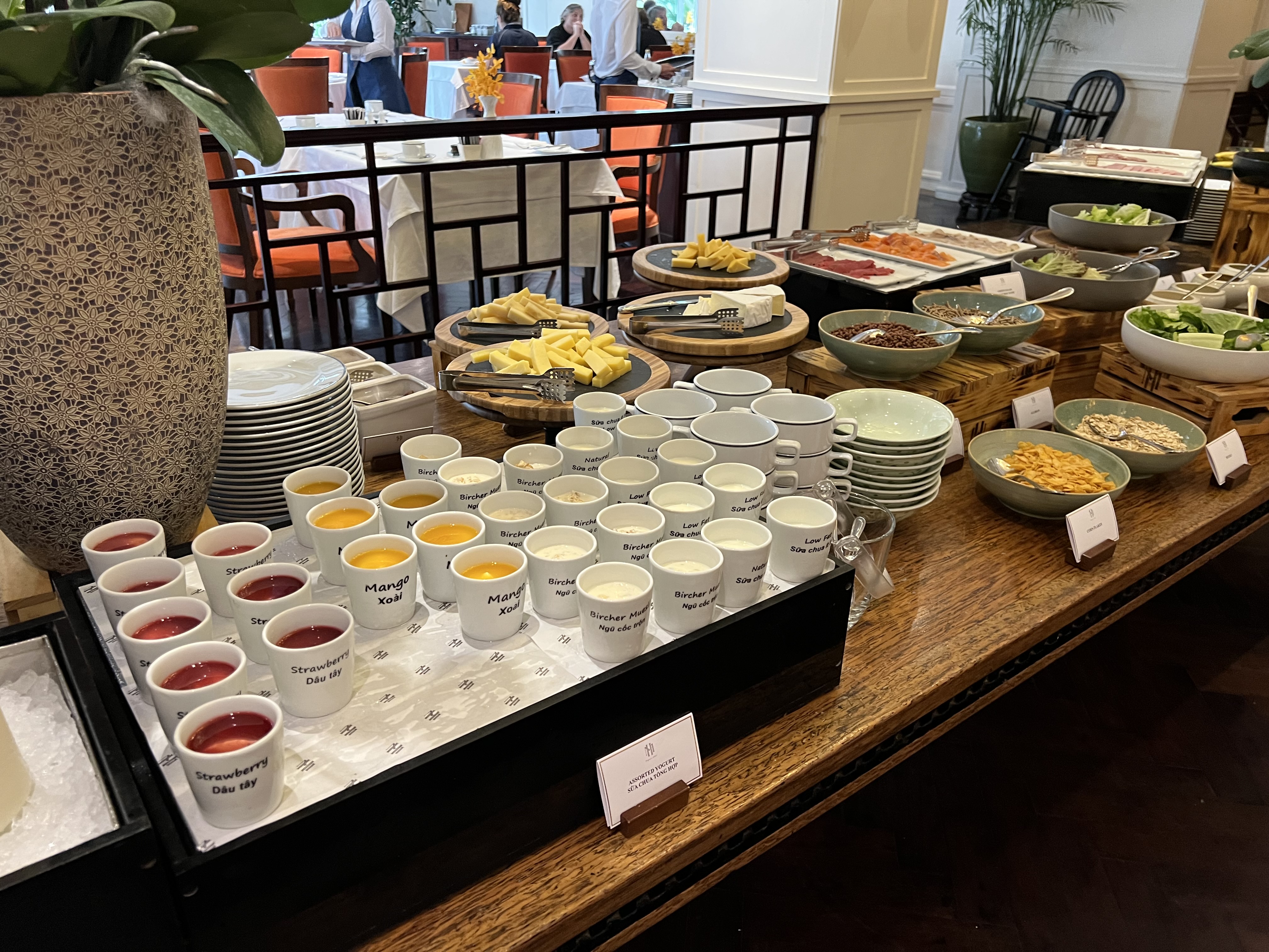 a buffet table with plates and cups of food