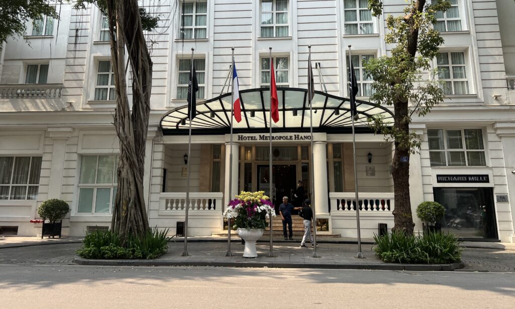 a building with flags and flowers