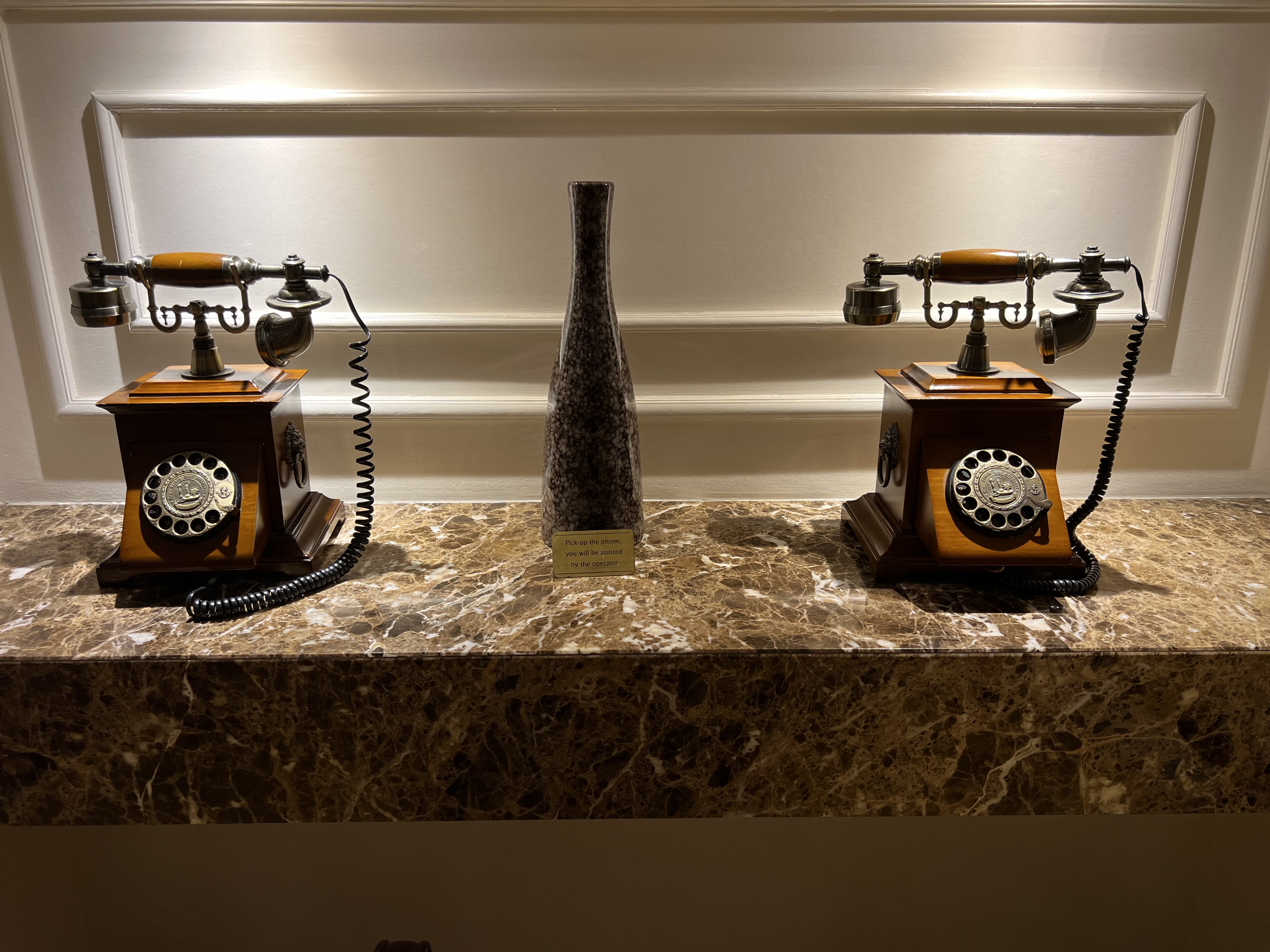 two telephones on a marble counter
