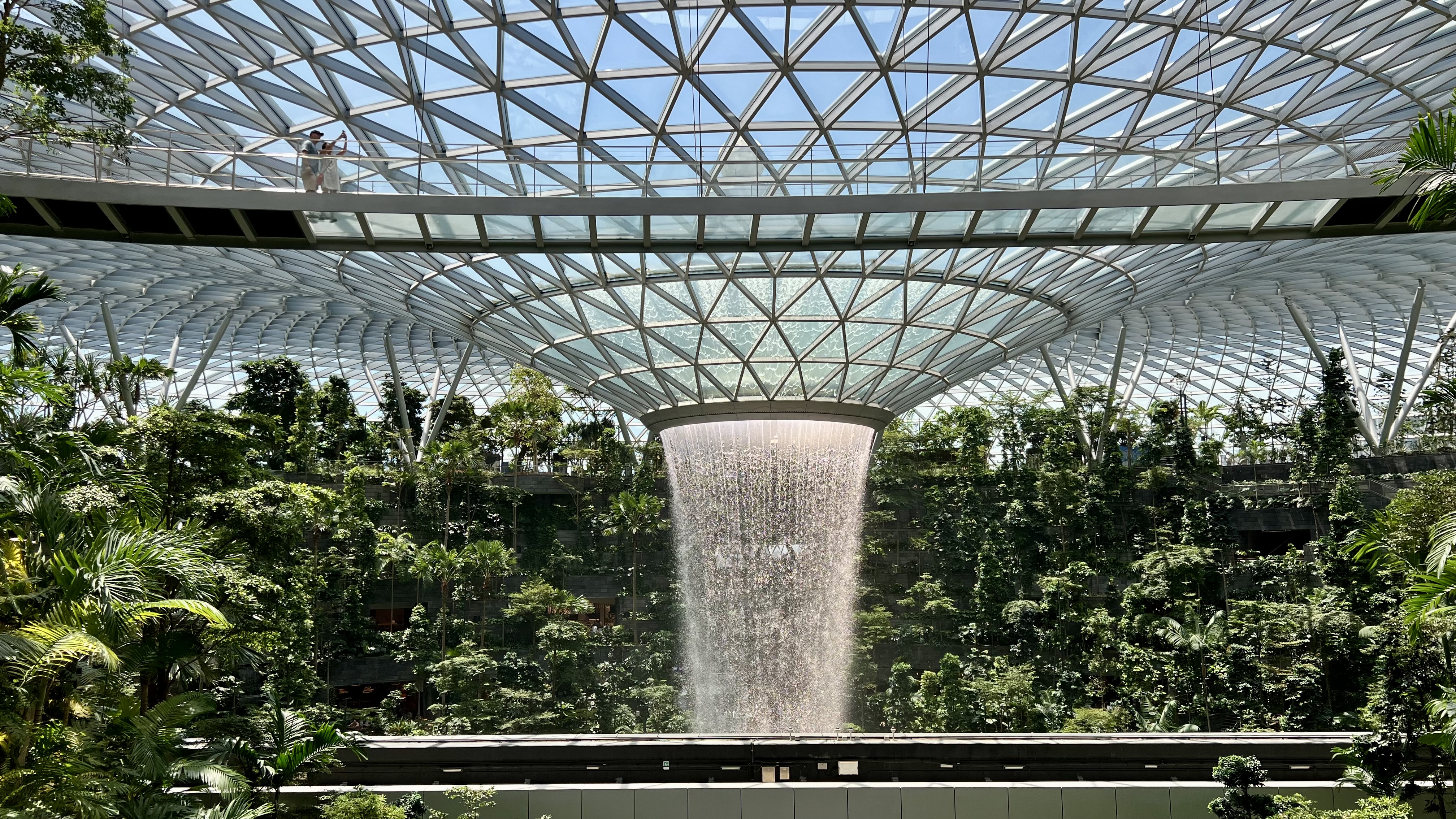a water falling from a glass roof