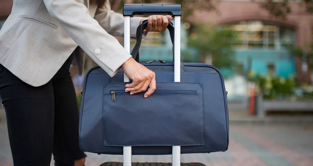 a person holding a blue bag