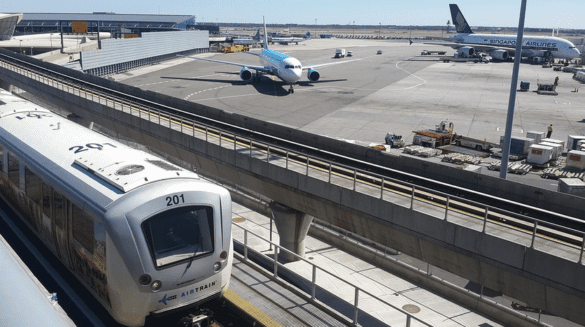 a train and airplanes at an airport