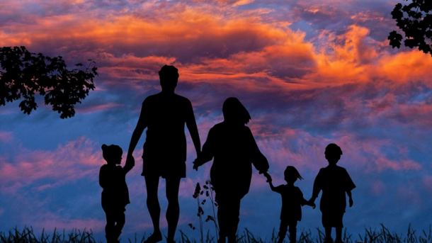 a group of people holding hands and walking