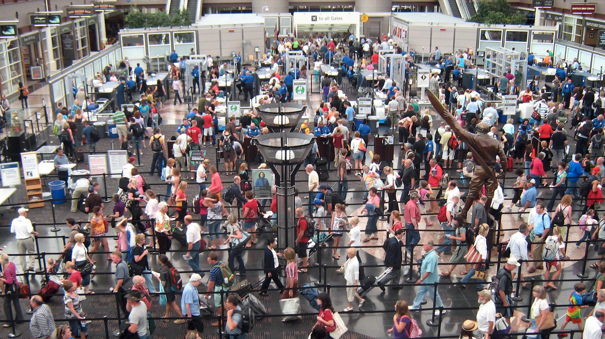 a crowd of people walking in a terminal