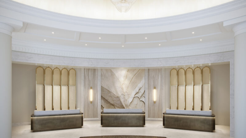 a lobby with marble walls and a white ceiling