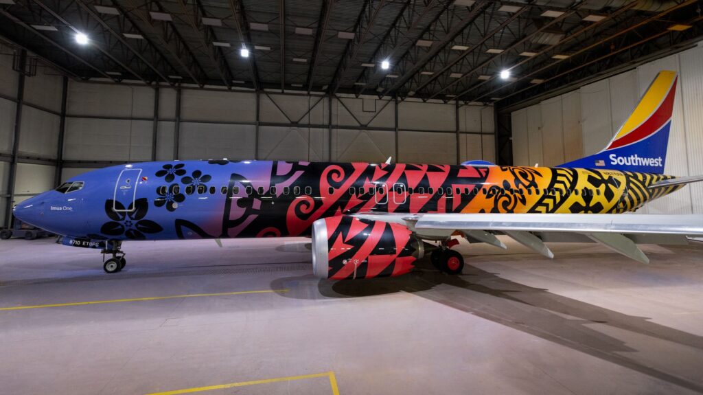 a colorful airplane in a hangar