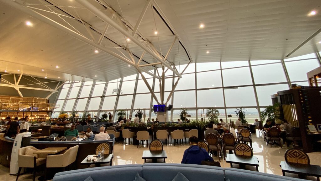 a large glass building with many tables and chairs