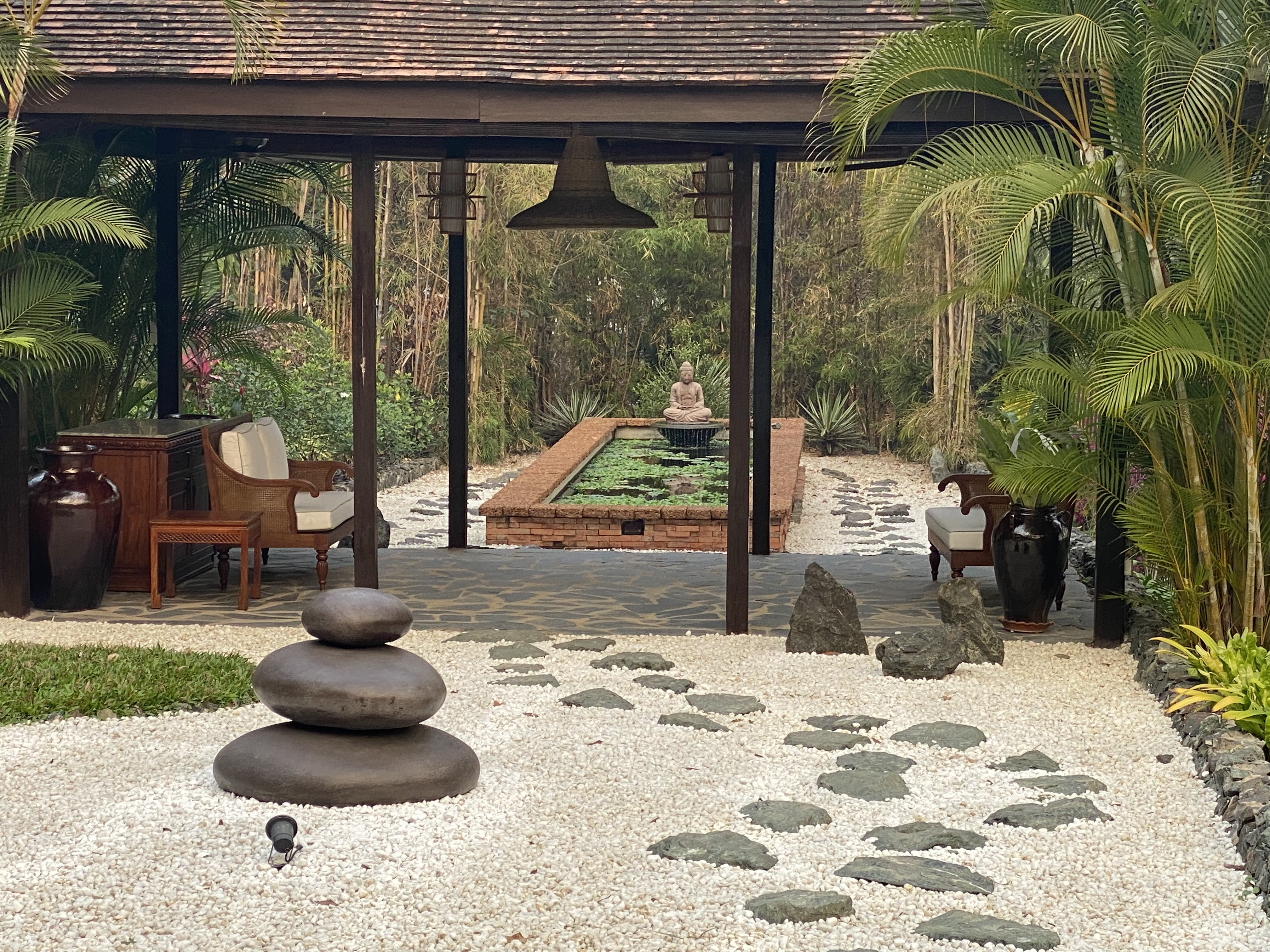 a patio with a stone walkway and a pool