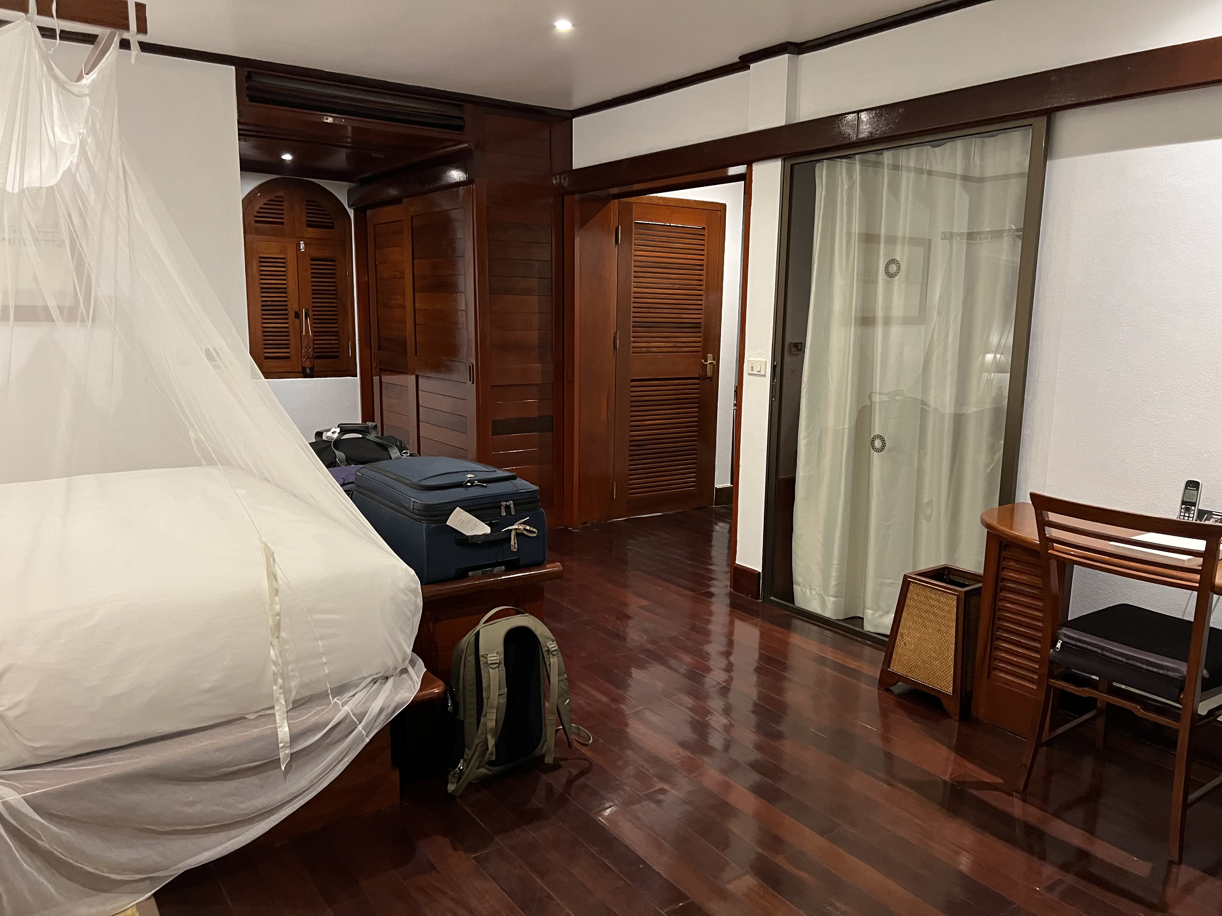 a room with a bed and luggage