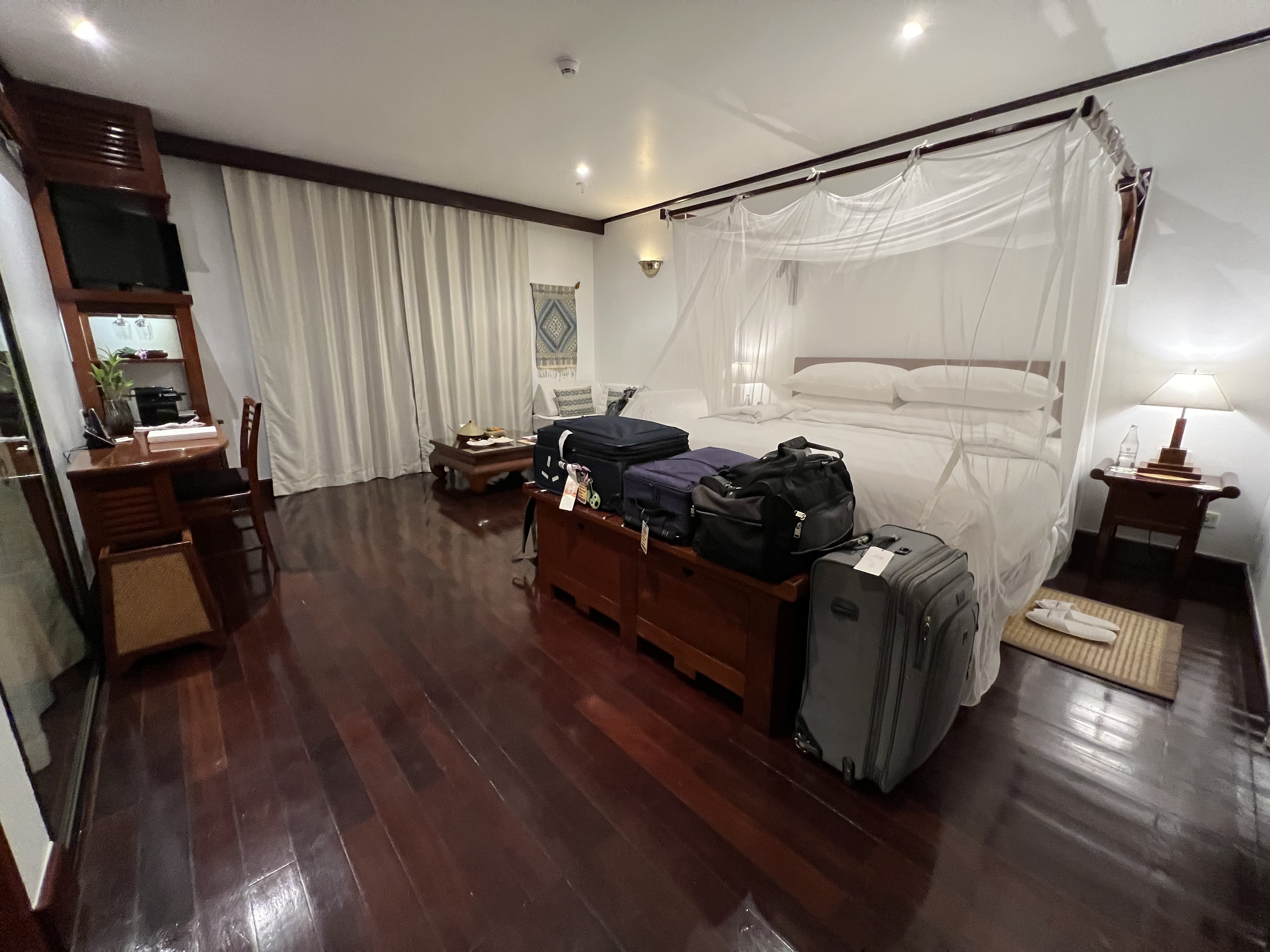 a room with a bed and luggage